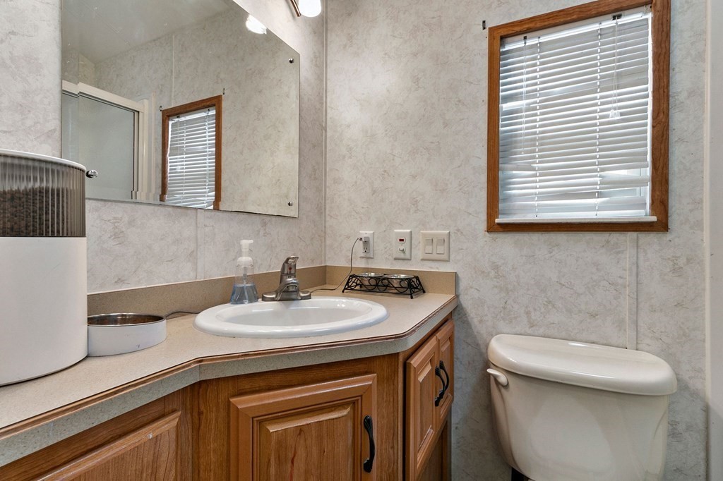 404 Southwick Road, Unit 9 Westfield, MA 01085 - Photo 21 of 30 a bathroom with a sink a toilet and a window