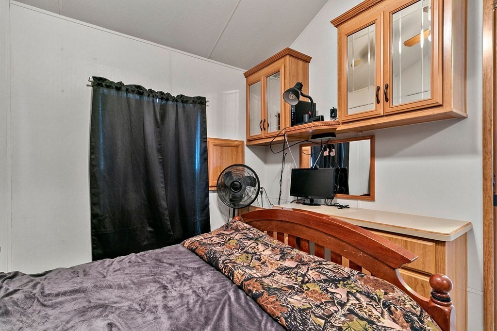 404 Southwick Road, Unit 9 Westfield, MA 01085 - Photo 23 of 30 a bedroom with a bed window and mirror