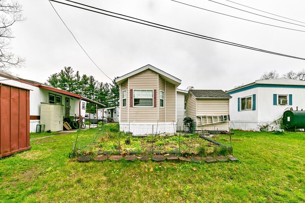 404 Southwick Road, Unit 9 Westfield, MA 01085 - Photo 29 of 30 a front view of a house with a yard and outdoor seating