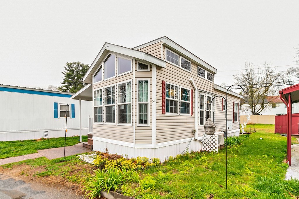 404 Southwick Road, Unit 9 Westfield, MA 01085 - Photo 3 of 30 a front view of a house with a yard