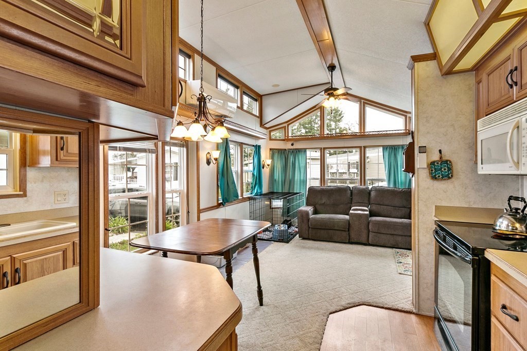 404 Southwick Road, Unit 9 Westfield, MA 01085 - Photo 7 of 30 a living room with furniture a large window and stainless steel appliances