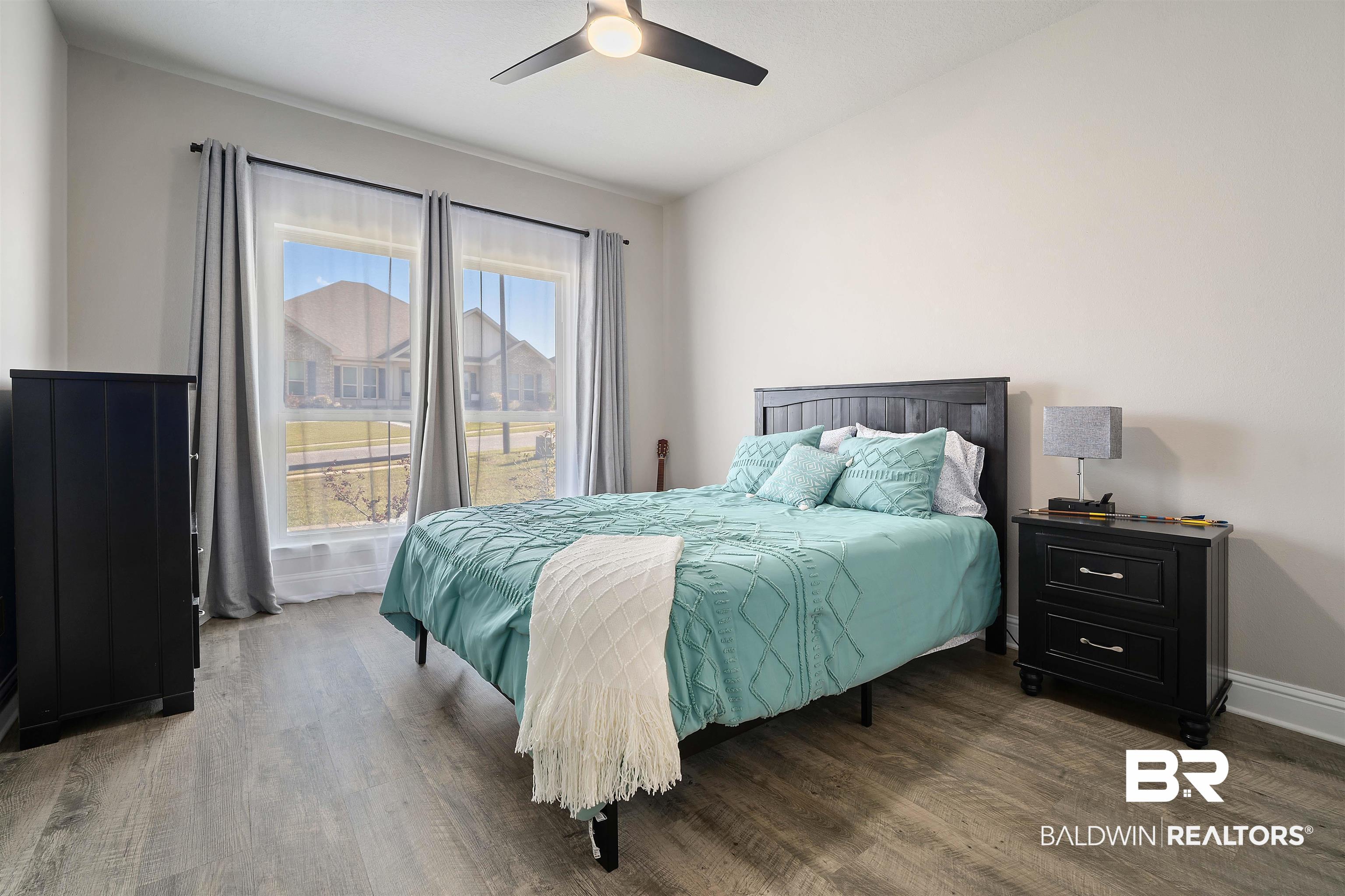 1700 Gwin Court Mobile, AL 36695 - Photo 22 of 36 Bedroom with dark wood-type flooring and a ceiling fan