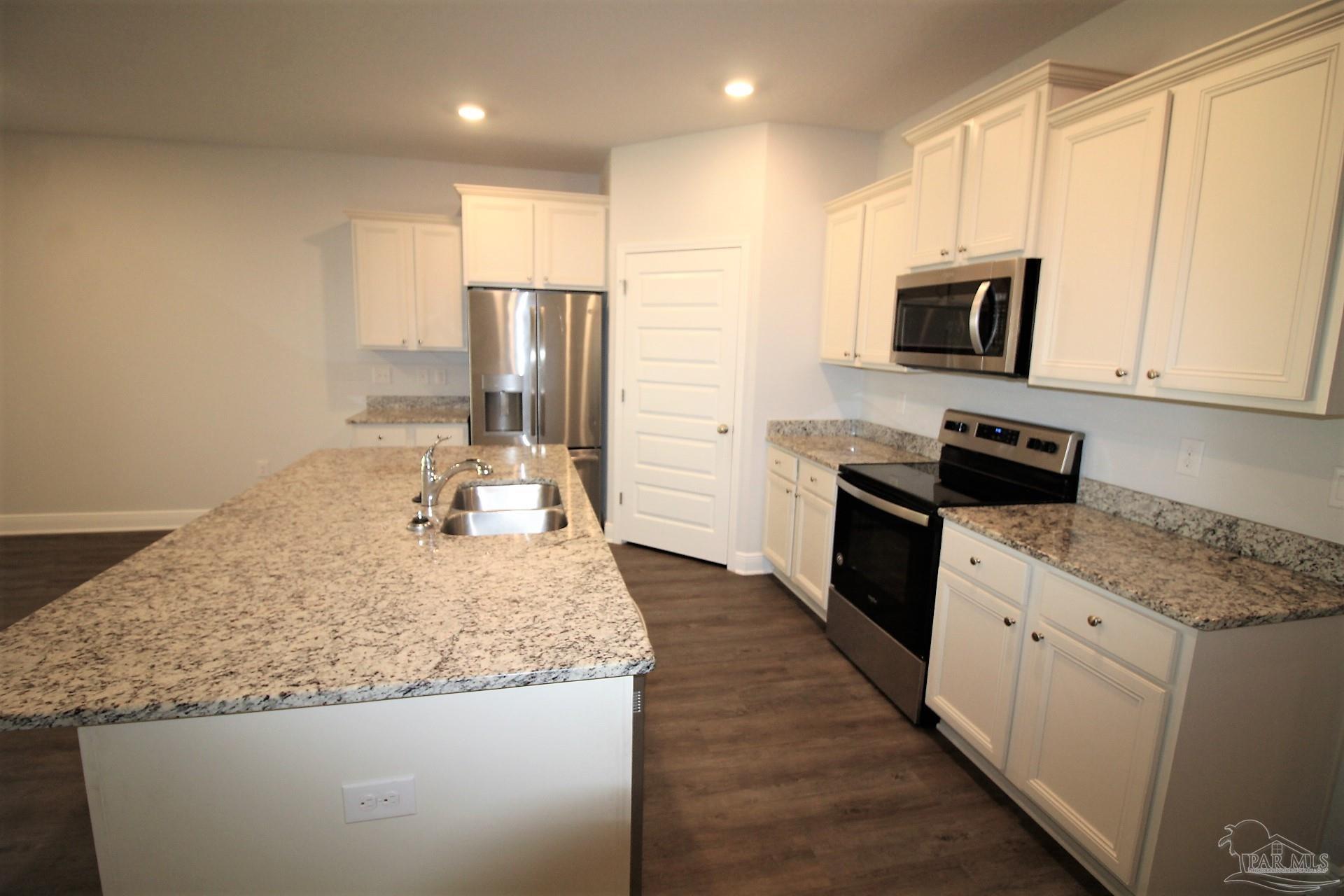 8006 Burnside Loop Pensacola, FL 32526 - Photo 10 of 22 a kitchen with stainless steel appliances granite countertop a sink stove and refrigerator