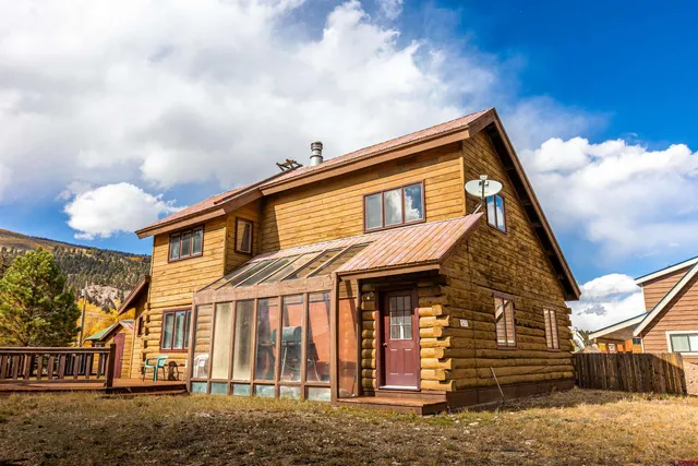 a view of a white house with a yard