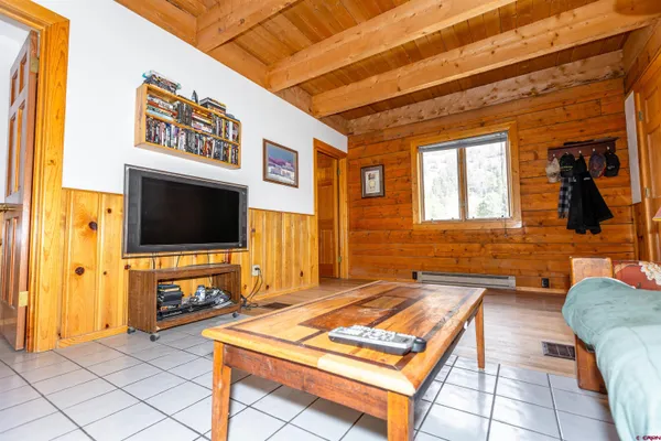 a view of a room with wooden floor and a window