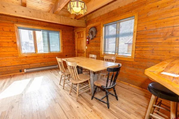 a view of a dining room with furniture and wooden floor