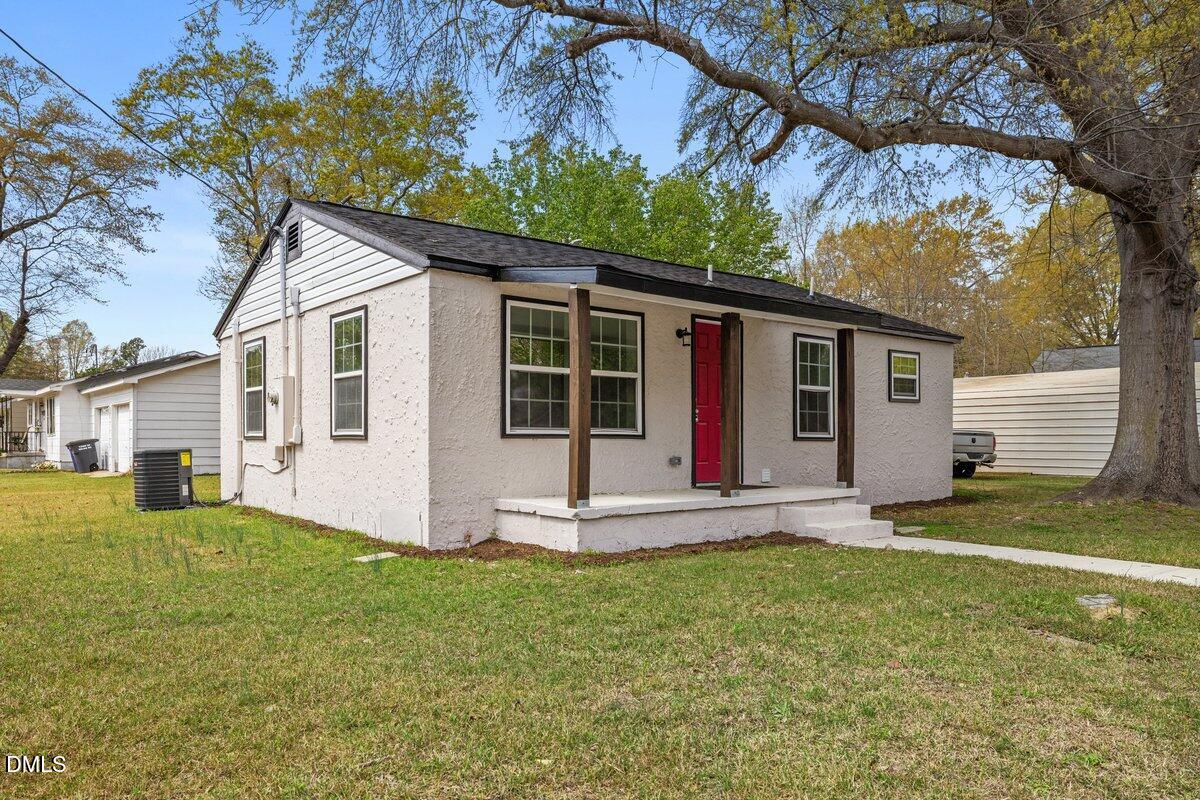 601 Temple Street Selma, NC 27576 - Photo 2 of 13 a big white house with a yard and large trees