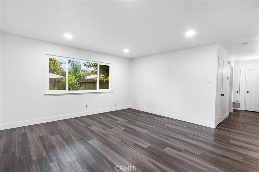 2618 Hoover Court Merced, CA 95340 - Photo 12 of 30 an empty room with wooden floor and windows