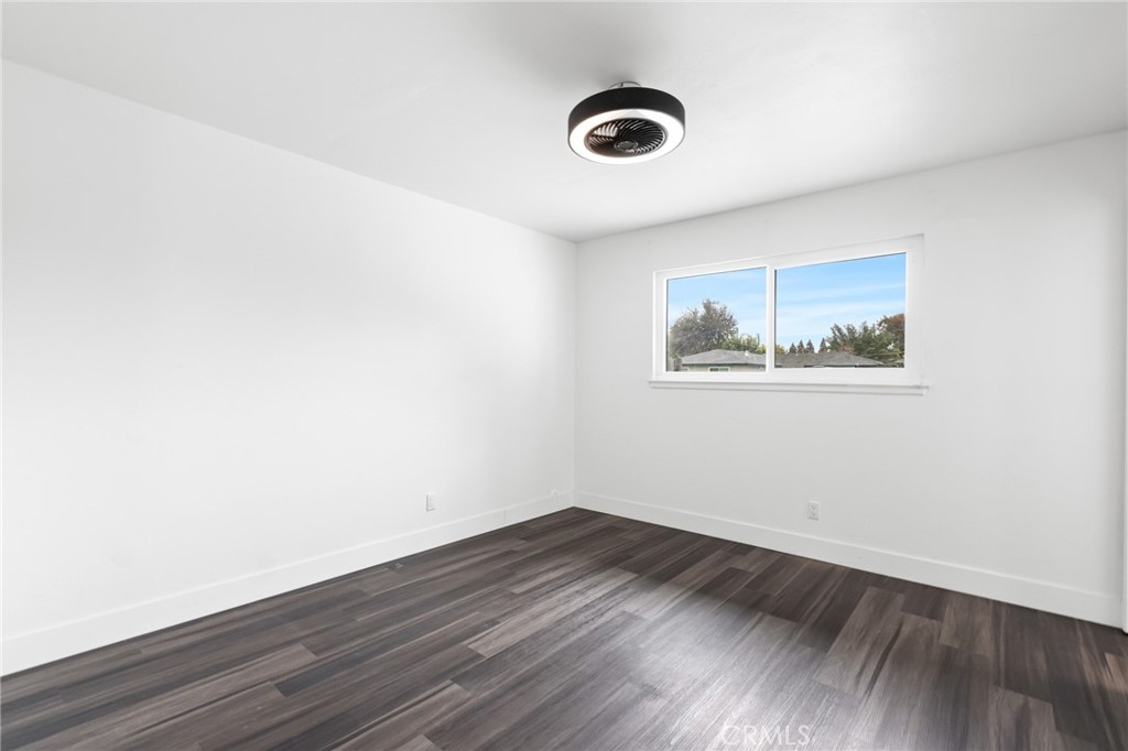 2618 Hoover Court Merced, CA 95340 - Photo 16 of 30 an empty room with wooden floor and windows