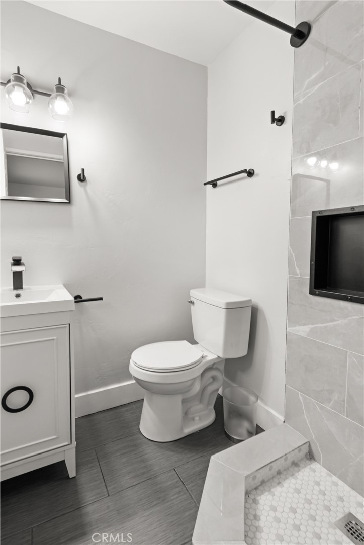 2618 Hoover Court Merced, CA 95340 - Photo 18 of 30 a white toilet sitting next to a bathroom sink