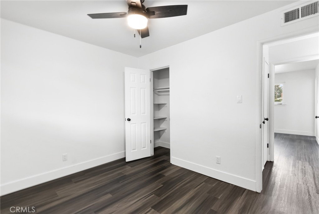 2618 Hoover Court Merced, CA 95340 - Photo 20 of 30 an empty room with wooden floor and ceiling fan