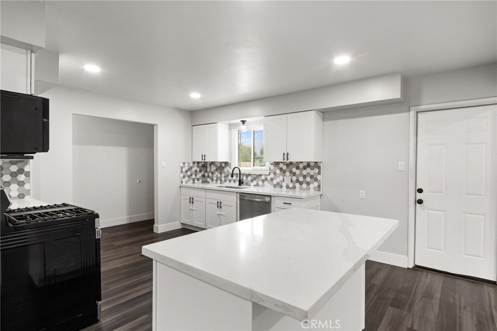 2618 Hoover Court Merced, CA 95340 - Photo 10 of 30 a kitchen with kitchen island a sink stainless steel appliances and cabinets