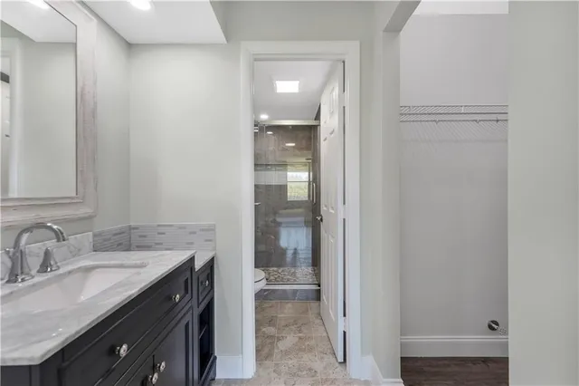 a bathroom with a granite countertop sink and a mirror