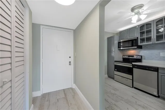 a kitchen with stainless steel appliances a stove a microwave and cabinets