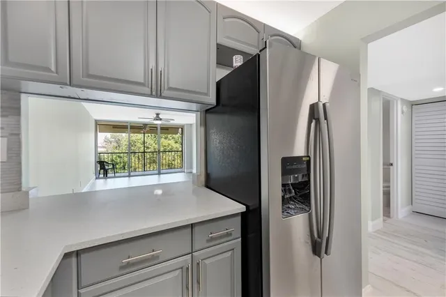a kitchen with stainless steel appliances a refrigerator and a window
