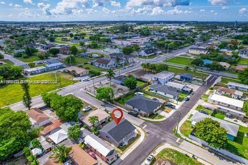 655 Southwest 5th Street Homestead, FL 33030 - Photo 2 of 23 an aerial view of a house with a garden and lake view