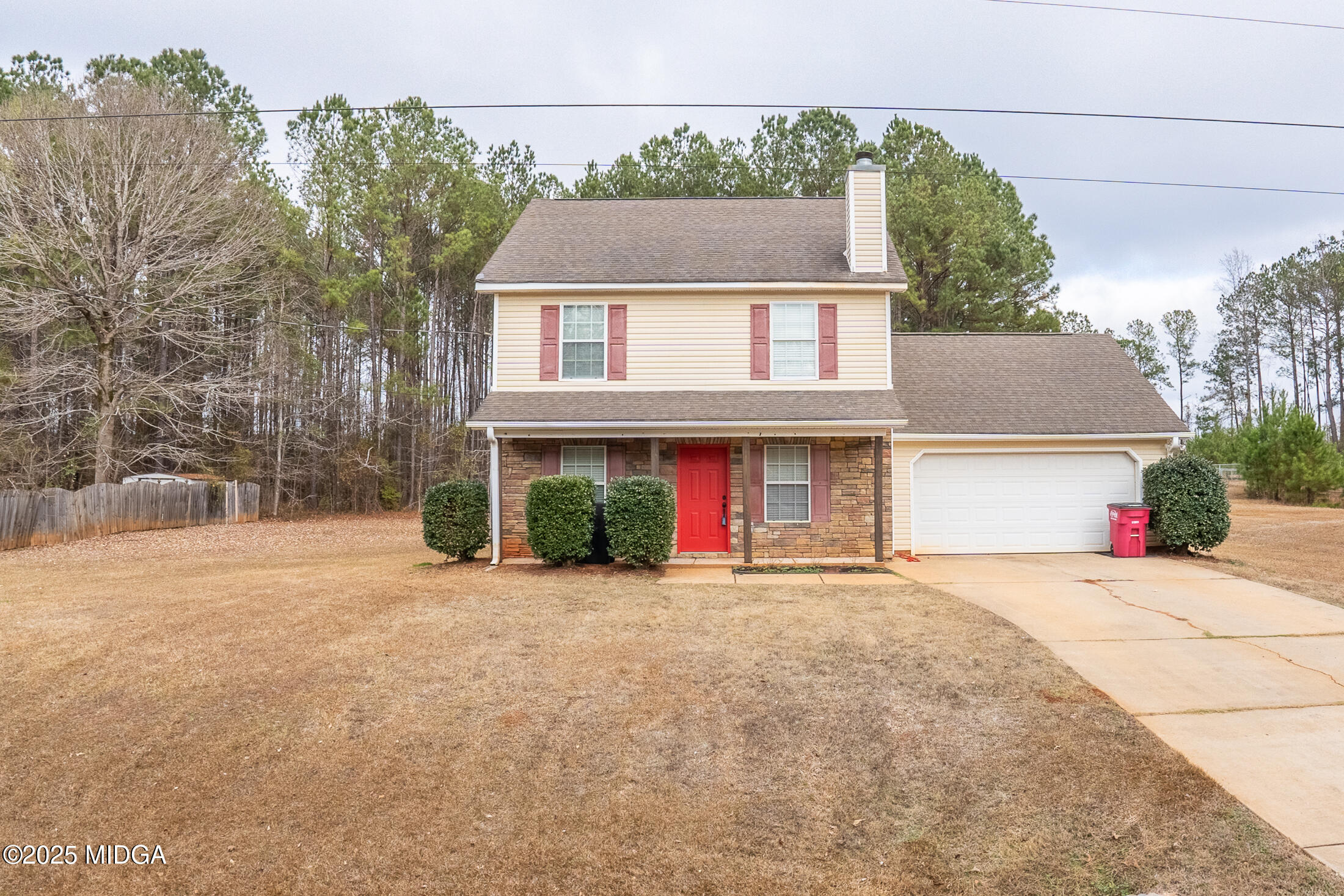 a front view of a house with a yard and a garage