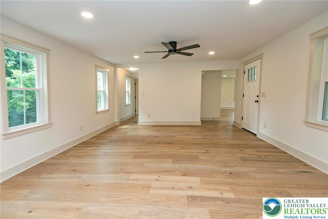 72 Allegheny Road Mount Bethel, PA 18343 - Photo 8 of 72 Natural light fills this generous living area, highlighting the rich hardwood flooring.