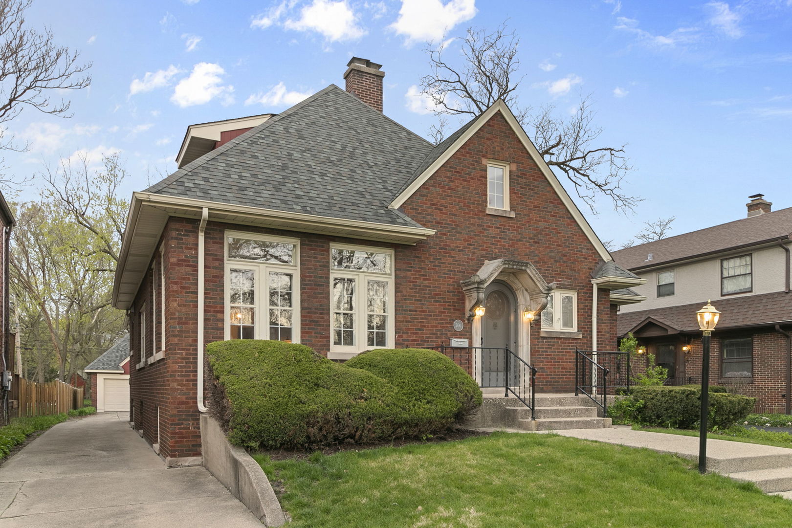 260 Bartram Road Riverside, IL 60546 - Photo 1 of 36 a front view of a house with a yard