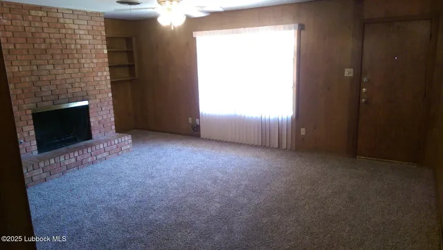 a view of an empty room with a fireplace