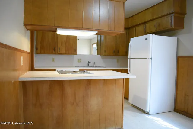 a white refrigerator freezer sitting in a kitchen