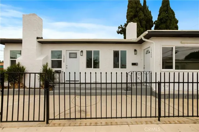 a view of a white house with a large window