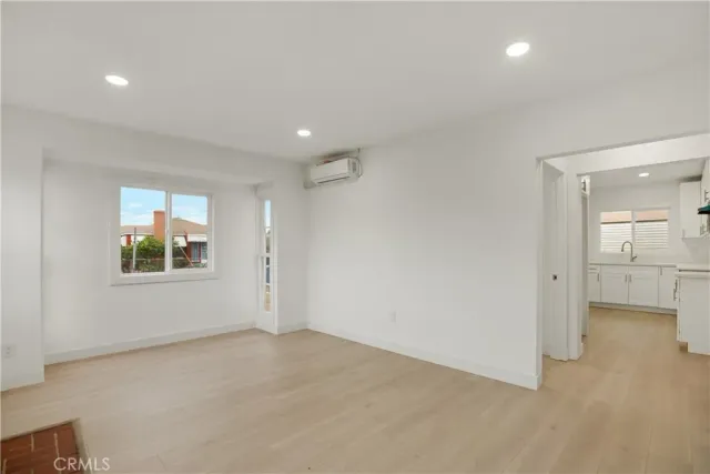 a view of a kitchen with white cabinets