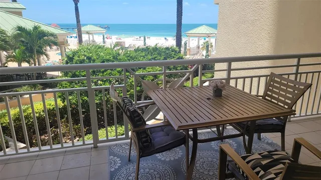 a view of a balcony with table and chairs