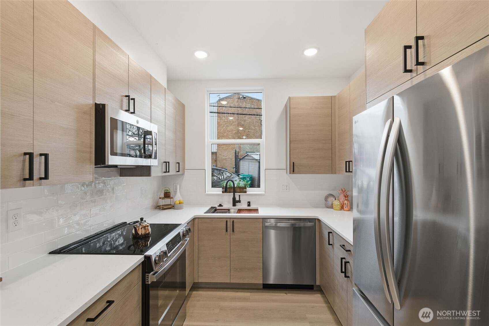 805 South Sullivan Street, Unit B Seattle, WA 98108 - Photo 11 of 20 a kitchen with stainless steel appliances granite countertop a sink stove and refrigerator