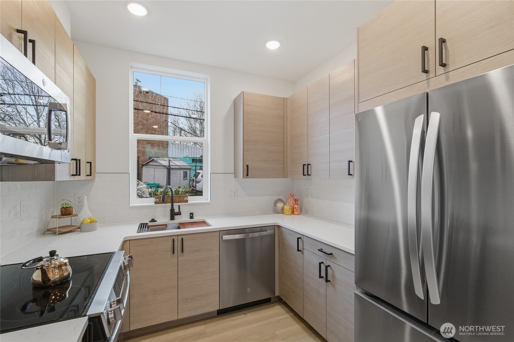 805 South Sullivan Street, Unit B Seattle, WA 98108 - Photo 12 of 20 a kitchen with a refrigerator sink and cabinets