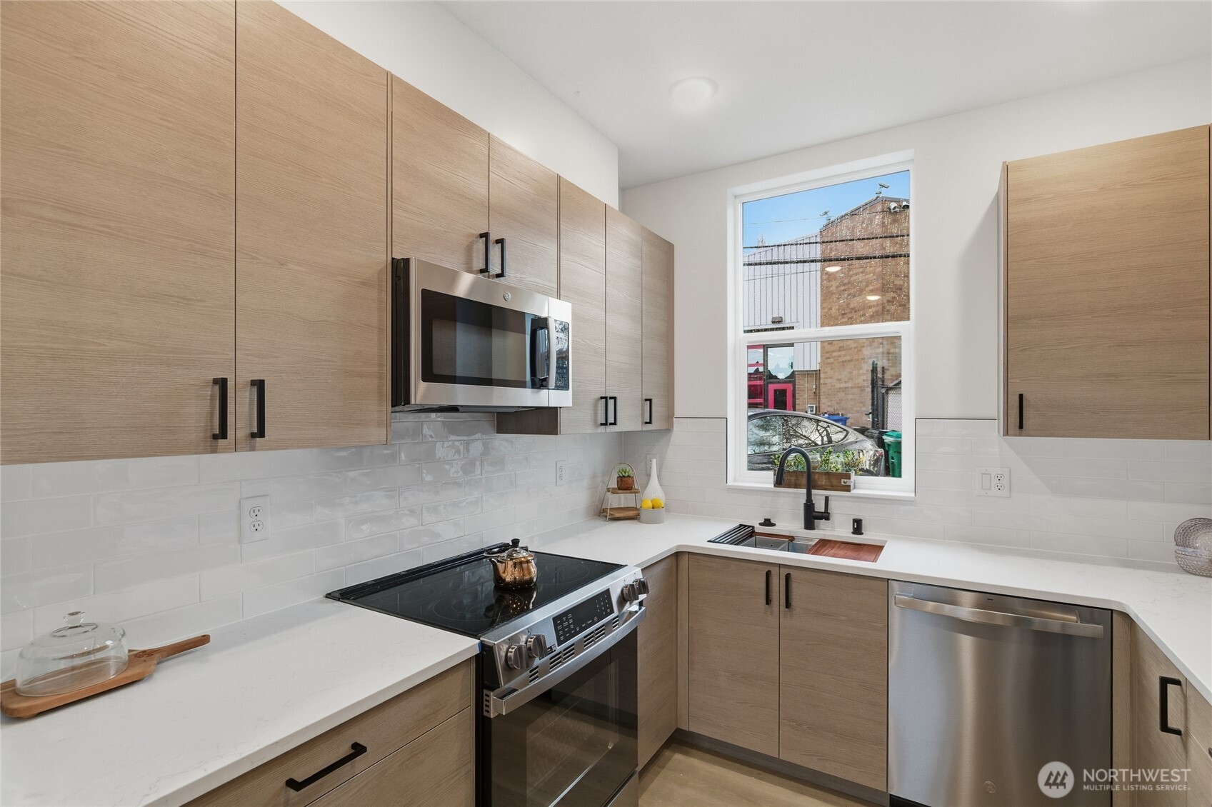 805 South Sullivan Street, Unit B Seattle, WA 98108 - Photo 13 of 20 a kitchen with a sink cabinets and stainless steel appliances