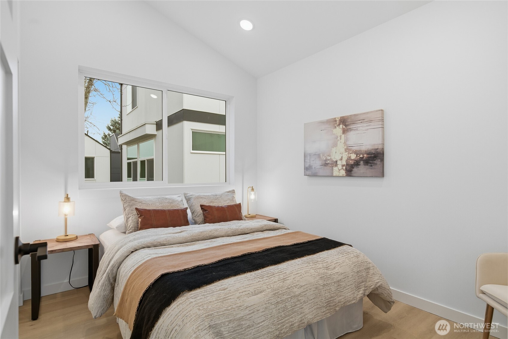 805 South Sullivan Street, Unit B Seattle, WA 98108 - Photo 18 of 20 a bedroom with a bed and a painting on the wall