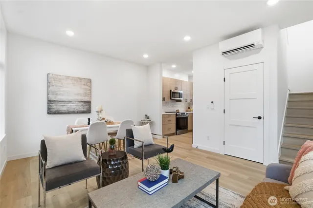 a living room with furniture and wooden floor