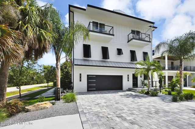 a kitchen with a dining table chairs sink and granite counter top