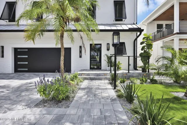 a spacious bedroom with a bed and a view of kitchen