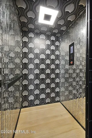 a view of an empty room with a kitchen