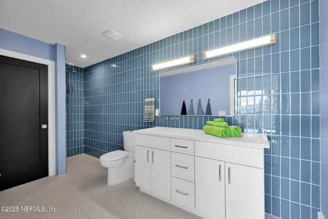 a large bed sitting in a bedroom next to a window