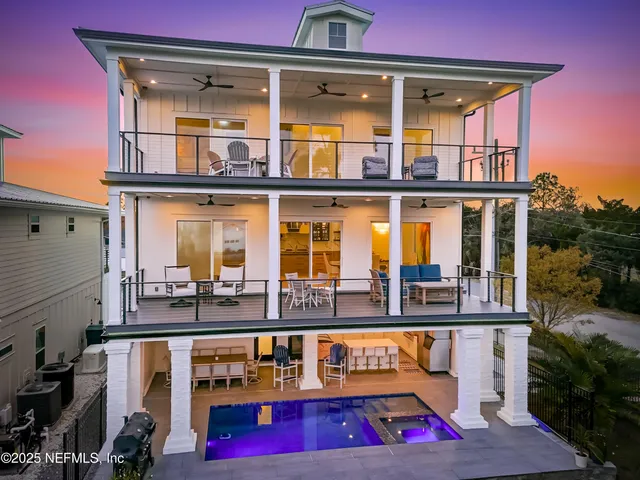 an aerial view of a house with a garden and lake view