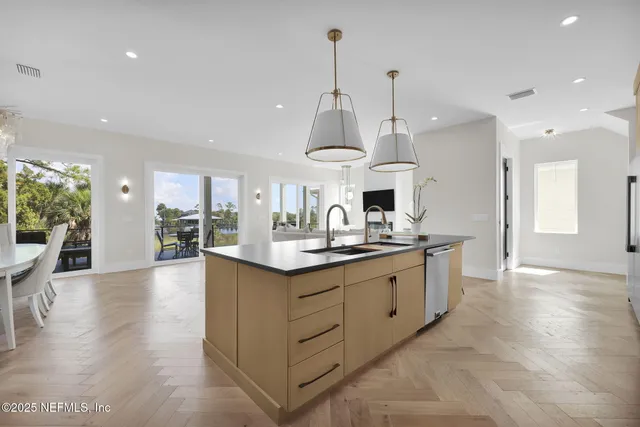 an aerial view of residential houses with outdoor space and swimming pool