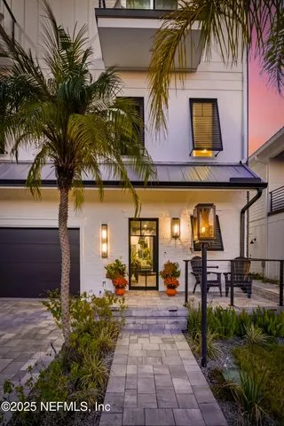 a dining room with furniture a chandelier and wooden floor