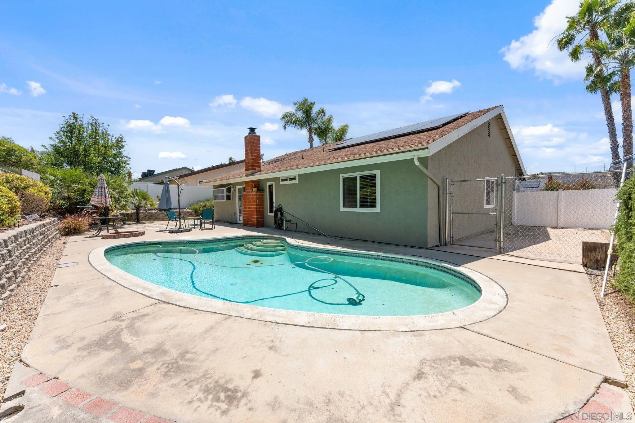 10565 Strathmore Drive Santee, CA 92071 - Photo 5 of 59 a view of a house with a swimming pool and a yard