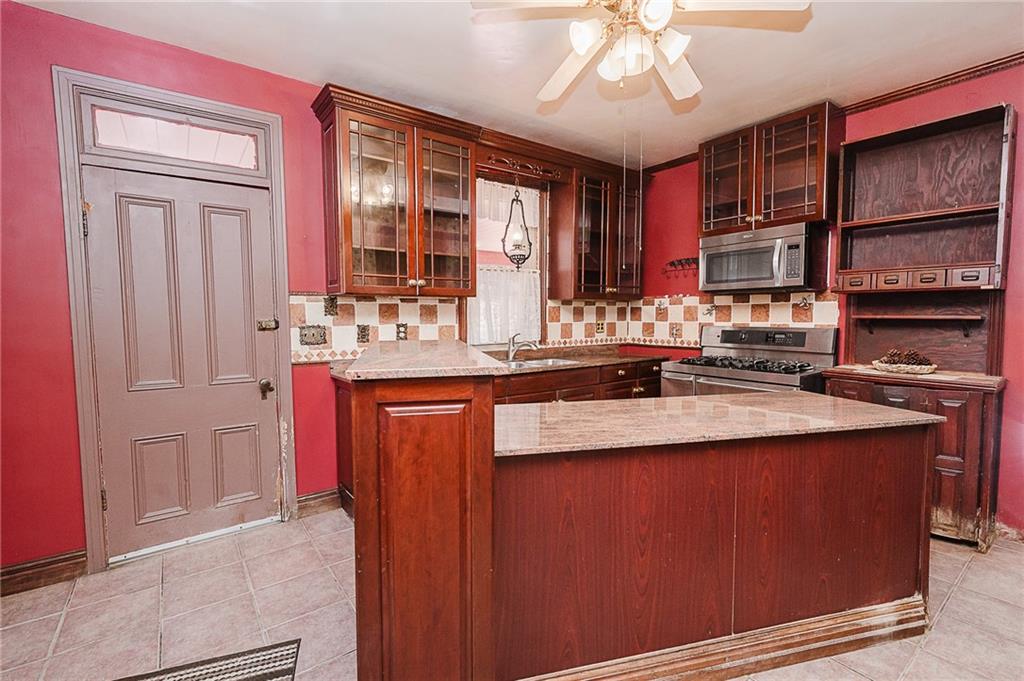 211 Old Mill Road Apollo, PA 15613 - Photo 12 of 42 a kitchen with stainless steel appliances granite countertop a sink and a refrigerator