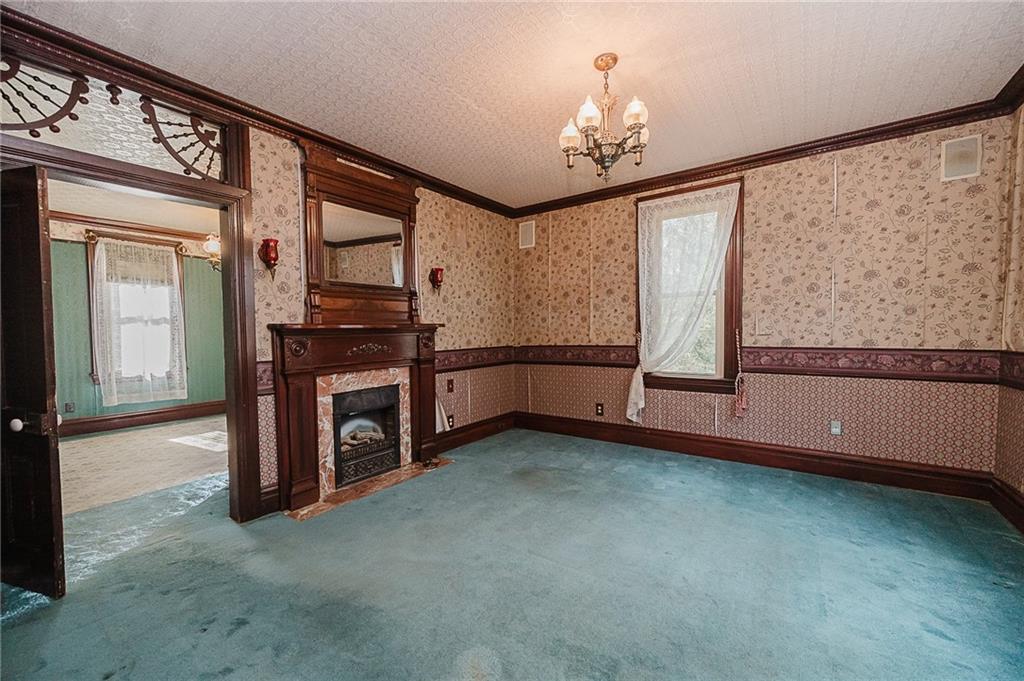 211 Old Mill Road Apollo, PA 15613 - Photo 19 of 42 a view of an empty room with chandelier fan and a large window