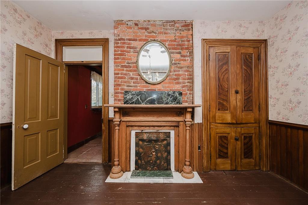 211 Old Mill Road Apollo, PA 15613 - Photo 7 of 42 a living room with a fireplace a clock and a clock on the wall