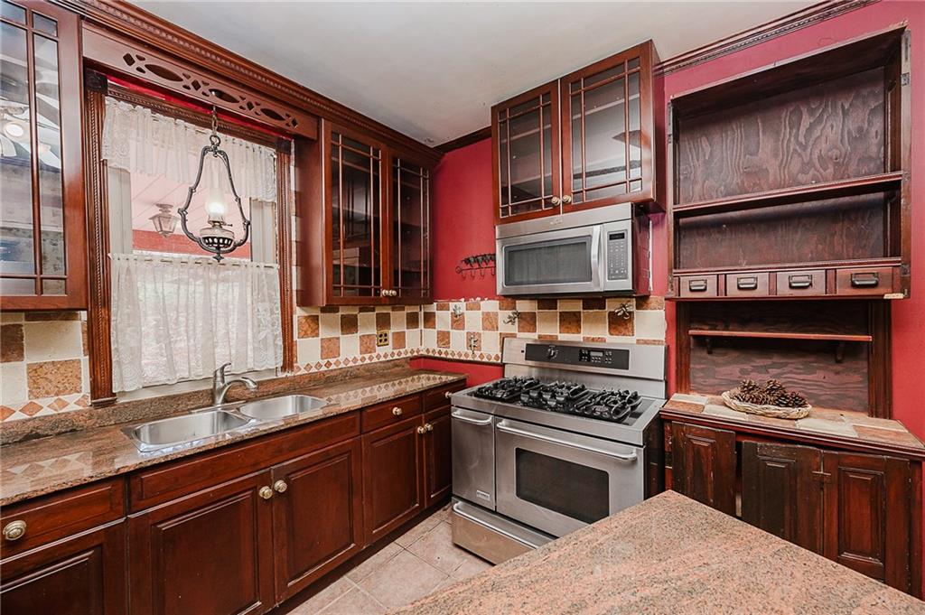 211 Old Mill Road Apollo, PA 15613 - Photo 9 of 42 a kitchen with stainless steel appliances granite countertop a stove and a sink