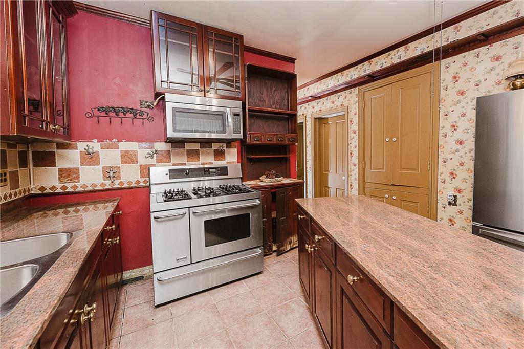 211 Old Mill Road Apollo, PA 15613 - Photo 10 of 42 a kitchen with stainless steel appliances granite countertop a stove and a refrigerator