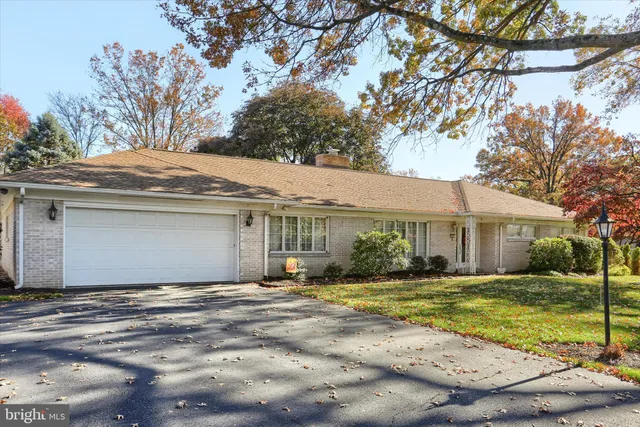 a front view of house with yard and trees around