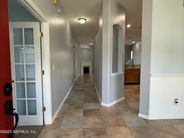 a view of a hallway with wooden shelves