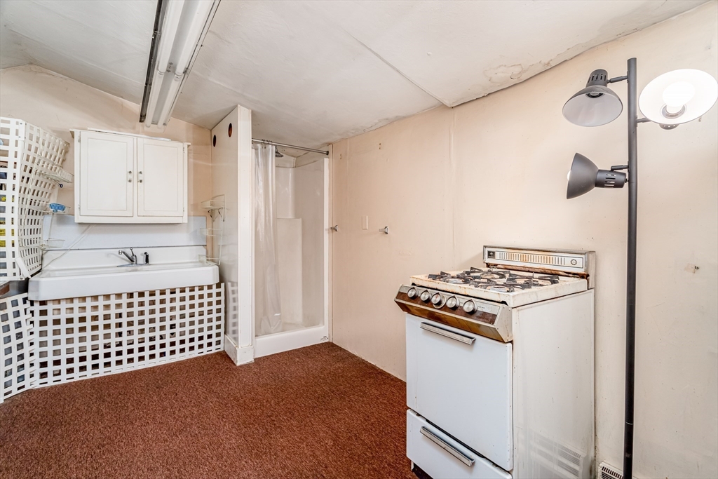 382 West Main Street Groton, MA 01450 - Photo 11 of 38 a kitchen with a stove and a refrigerator