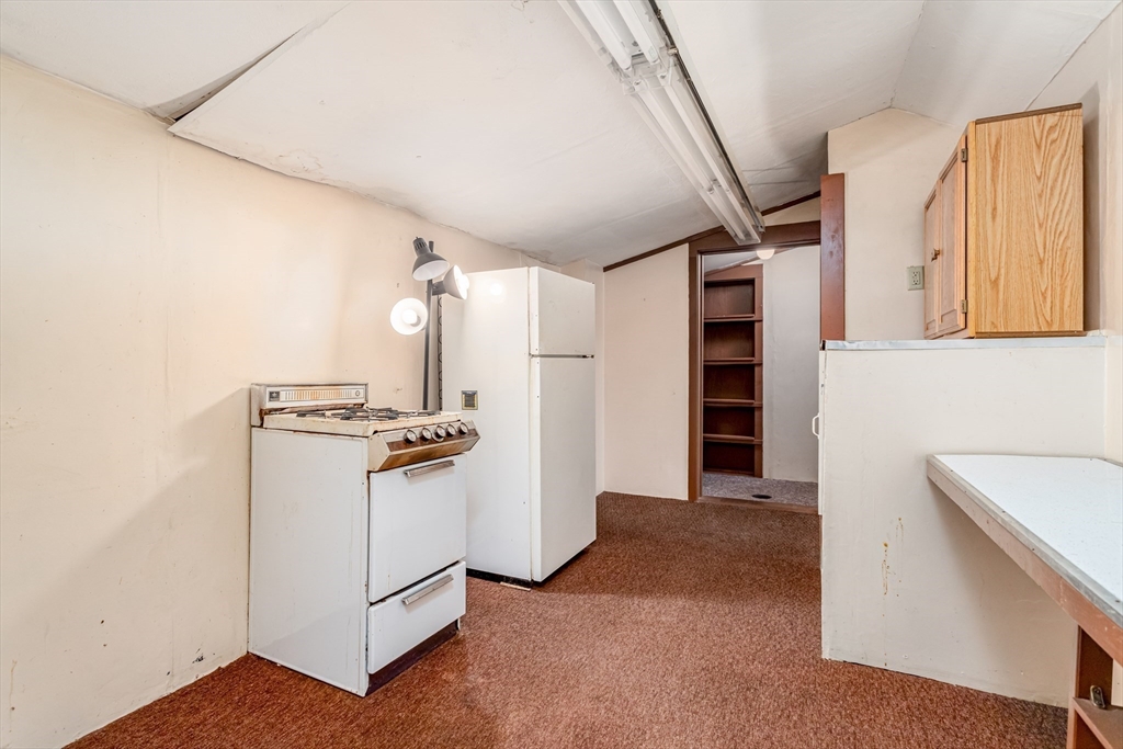 382 West Main Street Groton, MA 01450 - Photo 12 of 38 a kitchen with stainless steel appliances granite countertop a refrigerator and a stove